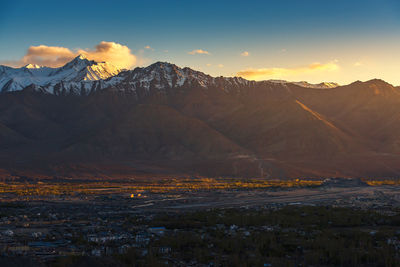 Scenic view of snowcapped mountains against sky during sunset