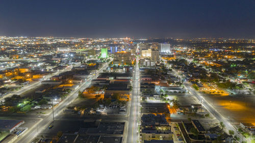 High angle view of illuminated city buildings at night