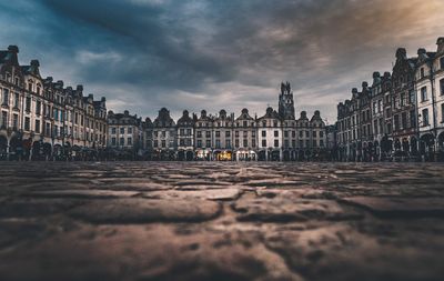 View of buildings in town against cloudy sky