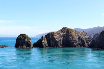 Panoramic view of sea and rock formation against sky