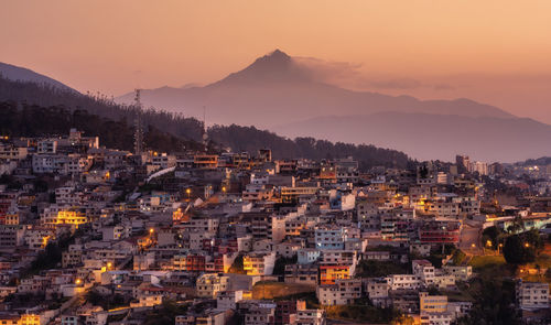 Townscape against sky during sunset