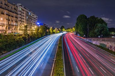 Light trails on road in city at night