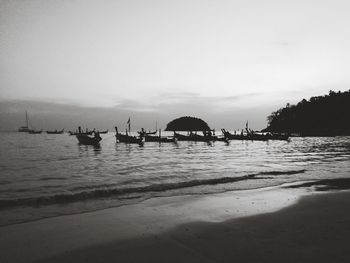 Silhouette pier over sea against sky