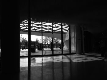 Silhouette man seen through glass window of building