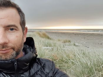 Portrait of man on beach against sky