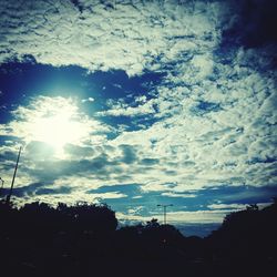 Low angle view of silhouette trees against sky at sunset