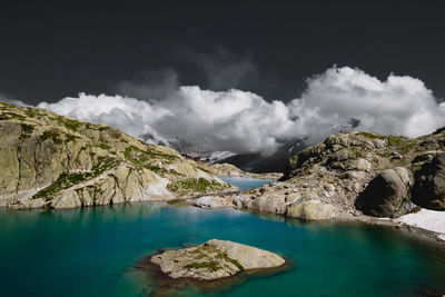 Panoramic view of lake and rocks against sky