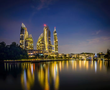 Illuminated building against sky at night