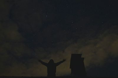 Low angle view of silhouette people at night