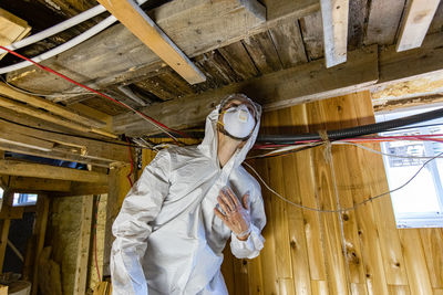 Low angle view of person standing on ceiling