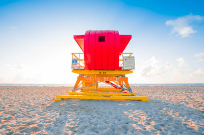 Lifeguard hut on beach against sky