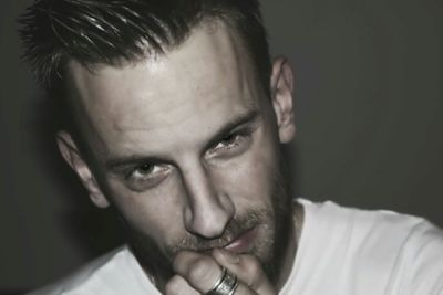 Close-up portrait of young man against wall