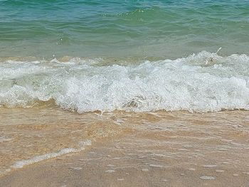 High angle view of waves rushing towards shore