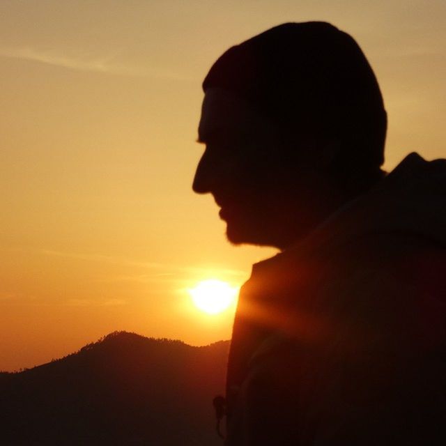 sunset, sun, silhouette, mountain, lifestyles, sky, scenics, beauty in nature, leisure activity, tranquility, tranquil scene, orange color, nature, men, person, rear view, idyllic, sunlight