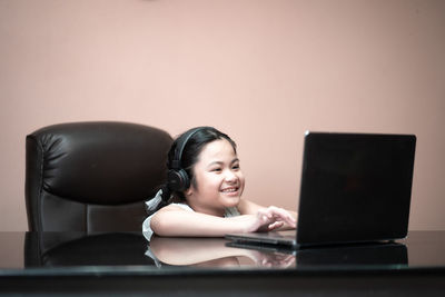 Portrait of smiling girl using mobile phone