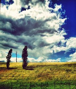 Scenic view of field against cloudy sky