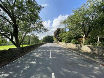 Looking along, leeds road, with stone walls and trees in, rawdon, leeds, uk