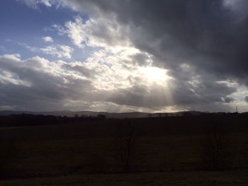 Scenic view of landscape against cloudy sky