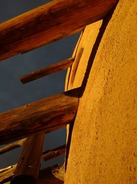 Low angle view of wooden structure against sky