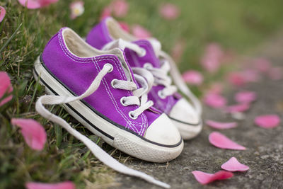 Close-up of purple shoes on grass