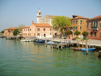 Boats in river with buildings in background