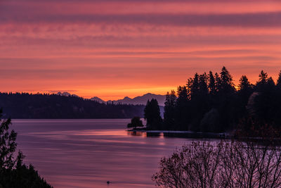 Scenic view of lake against romantic sky at sunset