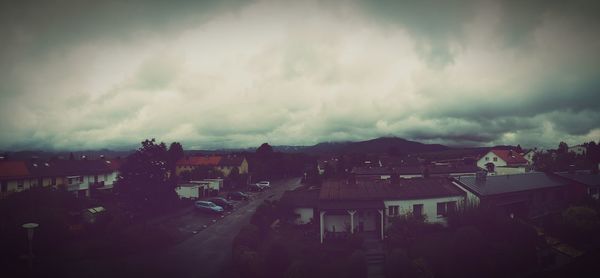 Buildings against cloudy sky