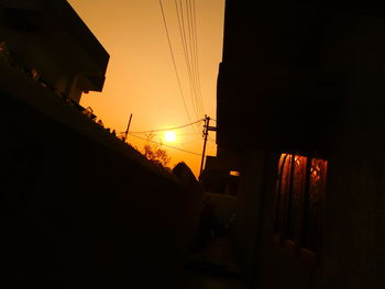 Low angle view of silhouette built structure against sky at sunset