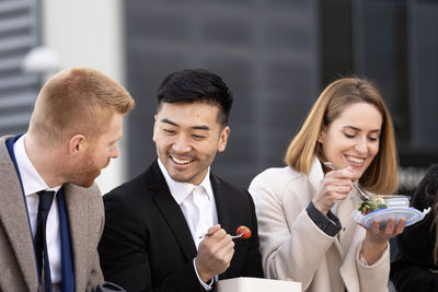 Side view of business colleagues discussing at office