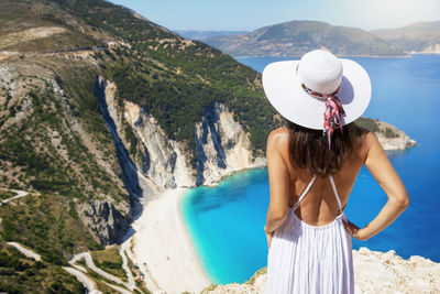 Rear view of woman wearing hat looking at view