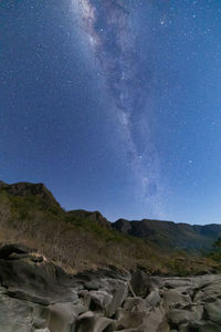 Scenic view of mountains against sky at night