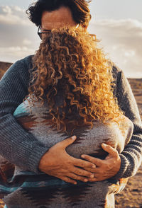 Rear view of woman looking away at beach