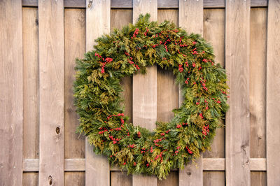 Close-up of wreath hanging on wooden wall