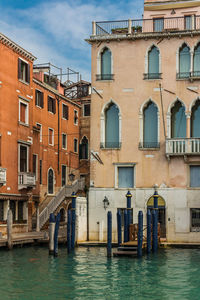 Buildings by canal in city