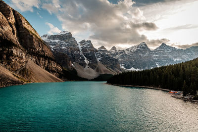 Scenic view of lake by mountains against sky