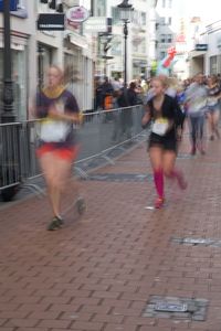 People running on street in city