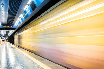 Blurred motion of train at railroad station