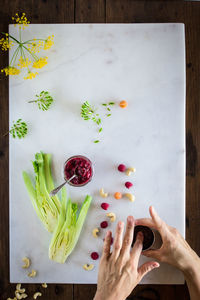 Directly above shot of woman hand on cutting board