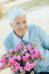 Portrait of young woman holding bouquet