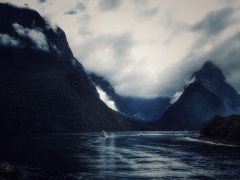 Scenic view of lake against cloudy sky