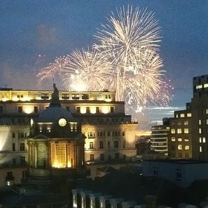 Firework display over river at night