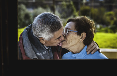 Close-up of senior couple kissing outdoors