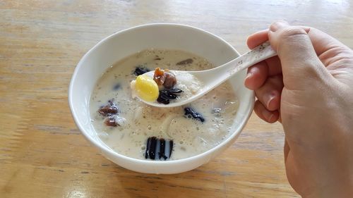 Midsection of person having food in bowl