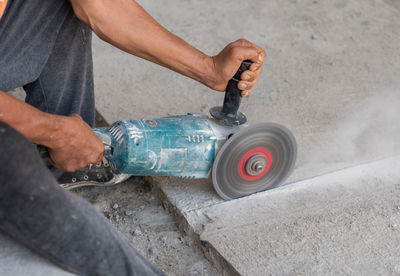 Low section of man repairing car