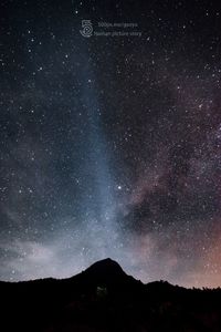 Scenic view of mountains against star field at night