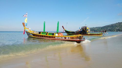 Ship moored on sea against sky