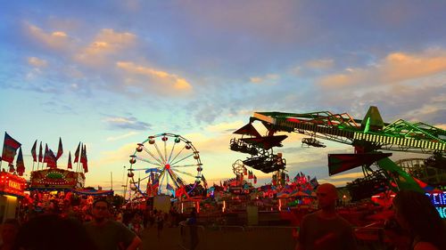 Low angle view of people in amusement park