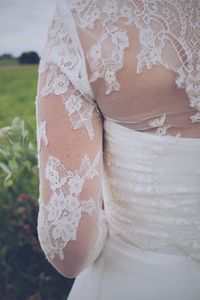 Midsection of bride standing outdoors