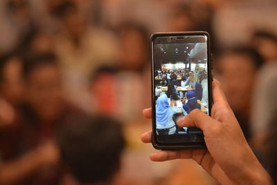 Man photographing through smart phone