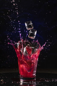 High angle view of wine glass against black background